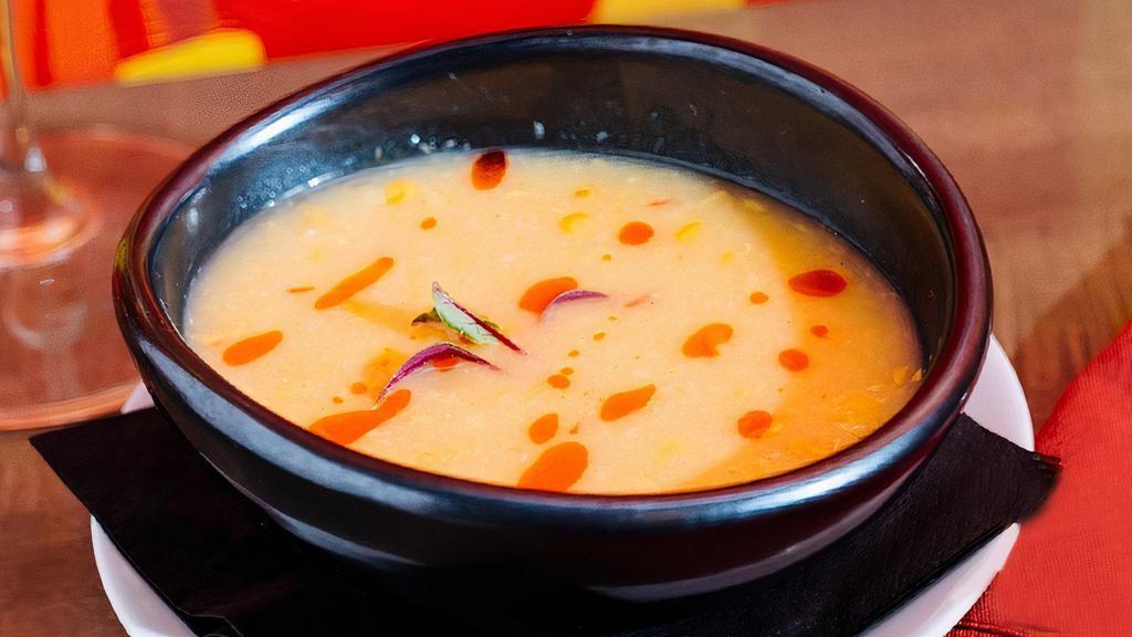 Spicy Corn Soup (V) · roasted sweet corn & fresh cilantro garnished with chili oil