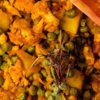 Gobhi Aloo (V, Gf) · cauliflower, peas, & potatoes stir fry and tossed in a blend of turmeric, cilantro, and chil...