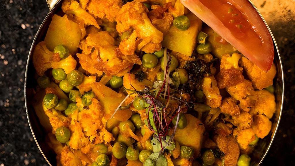 Gobhi Aloo (V, Gf) · cauliflower, peas, & potatoes stir fry and tossed in a blend of turmeric, cilantro, and chili powder