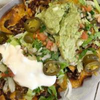 J & J Nachos Deluxe · Chips topped with refried beans, cheese, lettuce, pico de gallo, jalapeños, and sour cream.