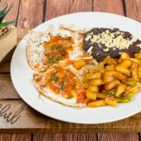 Huevos Rancheros · Two fried eggs on two corn tortillas with salsa, refried beans and home fries.