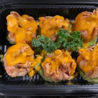Spicy Tuna Dumpling · Spicy. Fried dumpling filled with spicy tuna on top of lime spiced guacamole and drizzled wi...