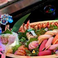 Love Boat · 18 pieces of sashimi and ten pieces of sushi (nigiri) , with a banzai roll and a flaming hea...
