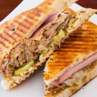 Cuban Panini (G.F.) · Slow roasted pulled pork, sliced ham, swiss cheese, pickles, and mustard pressed on a gluten...