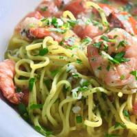 Shrimp Scampi · with garlic, parsley, and tomatoes, in a white wine sauce over linguini.