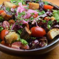 Mixed Greens Salad · with tomato, macerated onion, croutons, and balsamic vinaigrette.