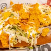 Taco Dog  { Sausage } · Topped with Ground Beef, Salsa, Shredded Lettuce, Cheese,  Sour Cream and Dorito Crumble