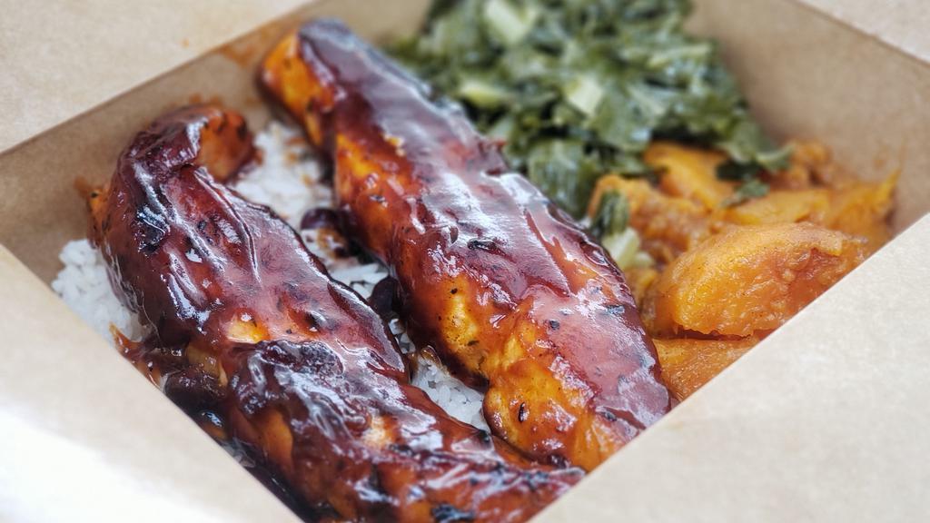 Bbq Salmon · Grilled Salmon Glazed in a Honey Hickory BBQ Sauce, Served with Rice and Peas, Collard Greens and Candied Yams