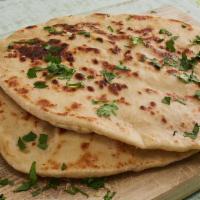 Peshwari Naan · Made with all-purpose white flour. Naan bread stuffed with cashew, raisins and topped with d...