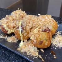 Takoyaki  · Japanese mountain-potato encrusted octopus topped with bonito flakes, Japanese mayo, and bar...