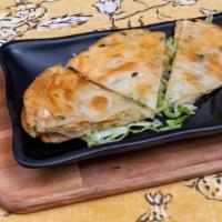 Scallion Pancake · a kind of pancake made with scallions. It is usually chewy, flaky, and savory.