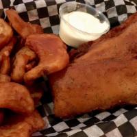 English Style Fish & Chips · Beer battered cod, fried golden brown, served with French fries, cole slaw and a lemon garli...