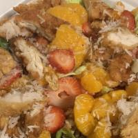 Mandarin Chicken Salad · Sesame marinated grilled chicken over mixed greens, topped with shredded coconut, strawberri...