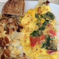Feta, Tomato, Spinach Omelette · Omelettes are made with three us grade a eggs and served with home fries and toast (white wh...