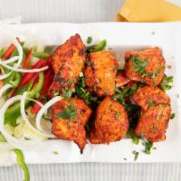 Tandoori Chicken · Tender chicken, marinated in yogurt and spices and broiled on skewers in our tandoor oven.