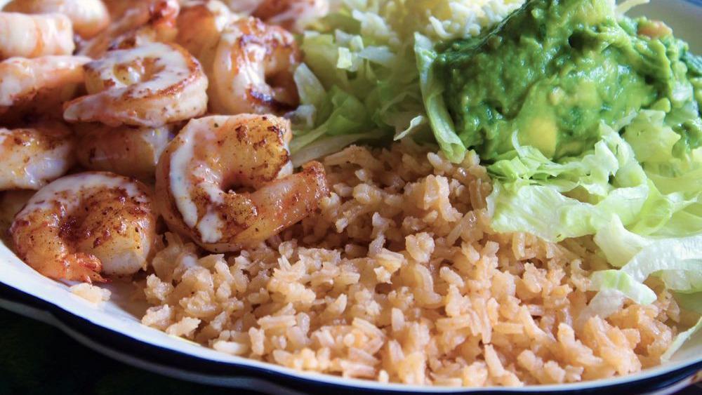 Camarones Mexicanos · Perfectly seasoned grilled Shrimp tossed in our special Cheese sauce. Served with Guacamole Salad, Spanish Rice, and Tortillas
