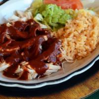 Mole Ranchero (Spicy) · Shredded Chicken drenched in our Ranchero Mole sauce. Served with Guacamole Salad, Spanish R...