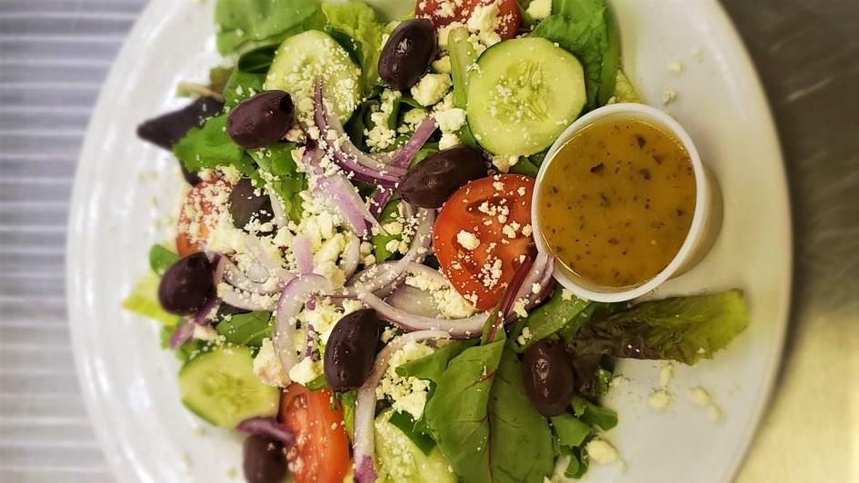 Greek Salad · Romaine, seasonal greens, tomatoes, feta, kalamata olives, cucumber, red onion, red wine vinaigrette.