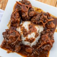 Oxtails With Two Sides · Beef oxtail, sauce, sweet peppers, carrots and beans.