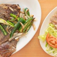 Chuleta Queretana · T-bone steak. Served with rice, beans, tomatoes, onion, peppers and salad.