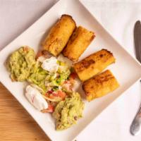 Taquitos Dorados · Crispy taquitos filled with chicken or beef and served with lettuce, Pico de gallo, guacamol...