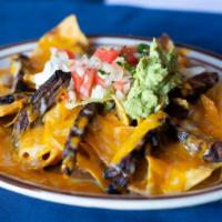 Nachos · Crispy corn tortilla chips covered with refried beans and melted cheese then topped with jal...
