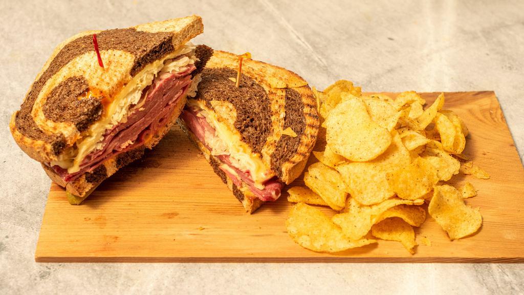 The “Smokin Hot” Reuben · A 1/2 pound of Hot Corned Beef with melted Swiss cheese, sauerkraut and Thousand Island dressing served on toasted Marble Rye. Bag of Chips and pickle spear included.