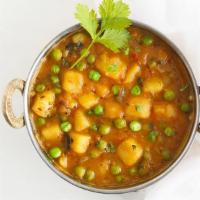  झोल वाले आलो मटर Jhol Wale Aloo Matar · Potatoes and green peas cooked in spiced onion and tomato gravy. Served with basmati rice. N...