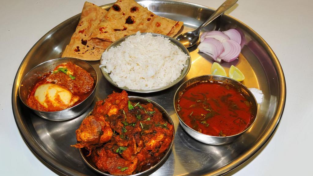  महाराजा थाली (मांस और चिकन)   Maharaja Thali (Meat & Chicken) · Choice of one  chicken entree and 1 meat entree. Served with basmati rice and 2 made-to-order tandoori roti or naan bread.