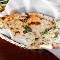 पनीर नान Paneer Naan · Two pieces. Seasoned Indian farmers cheese stuffed leavened bread bake in a clay oven.