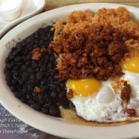 Huevos Rancheros · Two sunny-side up eggs over fried tortillas served with chorizo, rice, beans, sour cream, an...