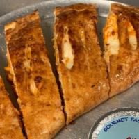 Chicken Stir Fry Calzone · Loaded with mozzarella cheese and pizza sauce on the side.