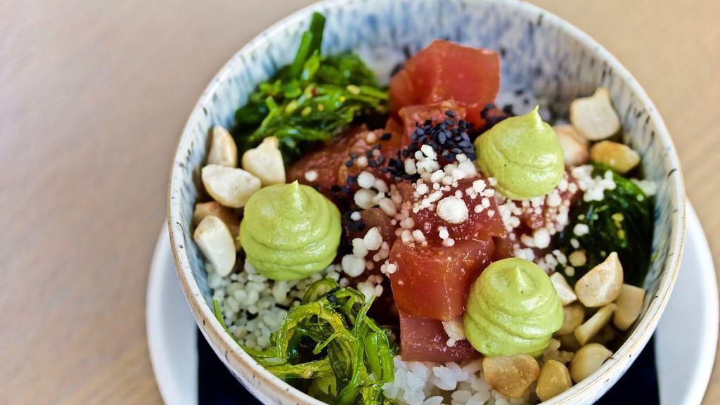 Tuna Poke Bowl · Large size of our tuna poke, ahi tuna, sticky rice, wakame, avocado mousse, wasabi ginger soy, tempura bits, macadamia nuts
