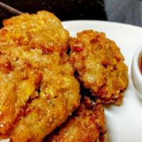 Corn Cakes  · Chopped corn mix with cornstarch, tofu and garlic spices, deep fried served with chill sweet...