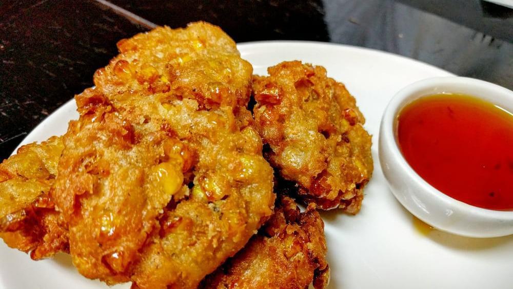 Corn Cakes  · Chopped corn mix with cornstarch, tofu and garlic spices, deep fried served with chill sweet sauce.