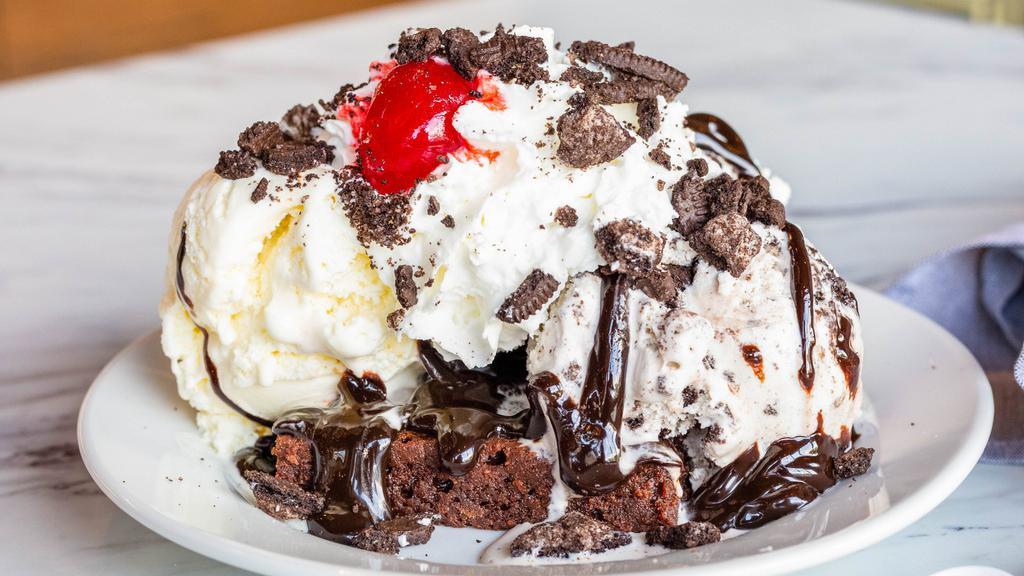 Brownie Sundae · Sundae served on a brownie with 2 wet toppings, 1 dry topping, and a cherry.