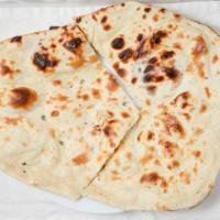 Butter Naan · Delicious clay pot baked Indian flatbread cooked with butter.