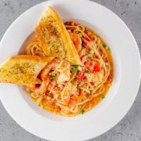 Shrimp Scampi Pasta · Sautéed shrimp tossed in fettuccine with tomato and garlic wine sauce.