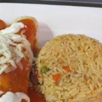 Enchiladas · 2 corn tortillas topped with guajillo sauce, cheese and sour cream. Served with rice, choice...