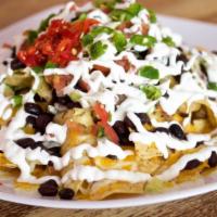 Nachos · Crispy corn tortilla chips covered with melted cheese, your choice of beans, lettuce, fresh ...