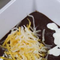 Homemade Black Bean Soup · Topped with cheese, sour cream and pico de gallo.