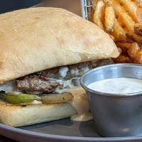 Carne Asada Steak And Cheese  · Served on a ciabatta roll.  Toppings include: grilled onions, grilled peppers, American chee...