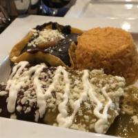Cholo Enchiladas · Salsa verde and mole chicken enchiladas, topped with queso fresco and sour cream. Served wit...