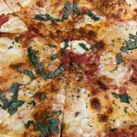 Margarita Pizza · Fresh buffalo mozzarella and fresh basil. pizza dough made from scratch topped with mozzarel...