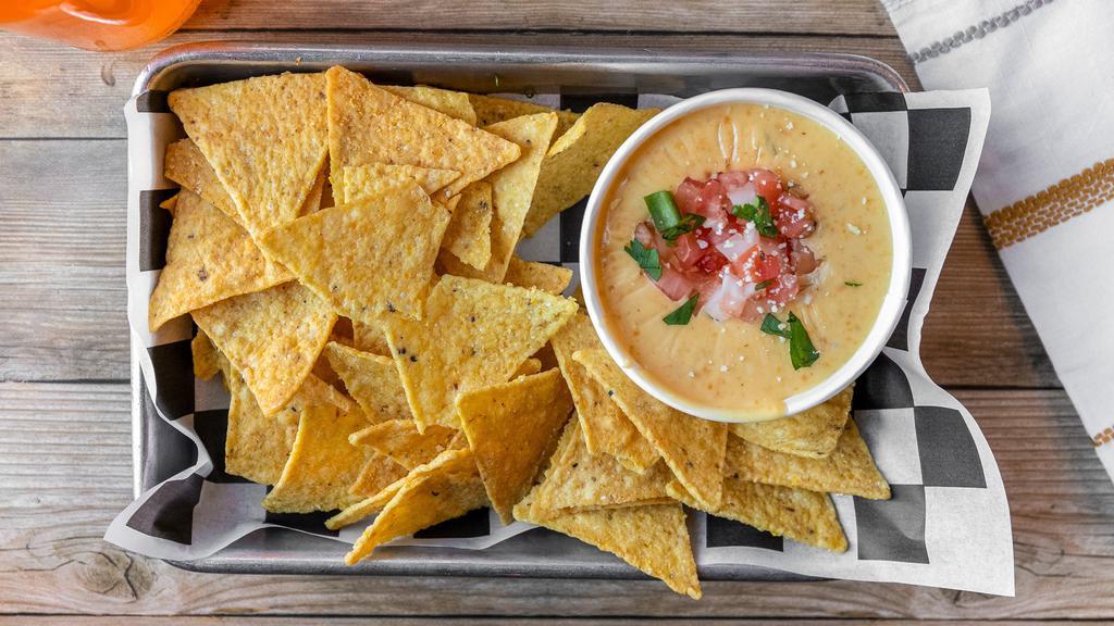 Chips & Queso · House made queso with jalapeños and green chilies. Comes with a scoop of fresh pico de gallo.