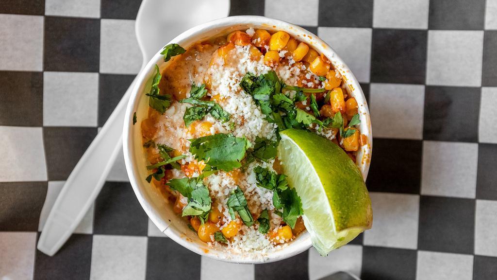 Street Corn · Our take on the classic Mexican street corn. Topped with cotija cheese, our house made esquites sauce and a lime wedge.