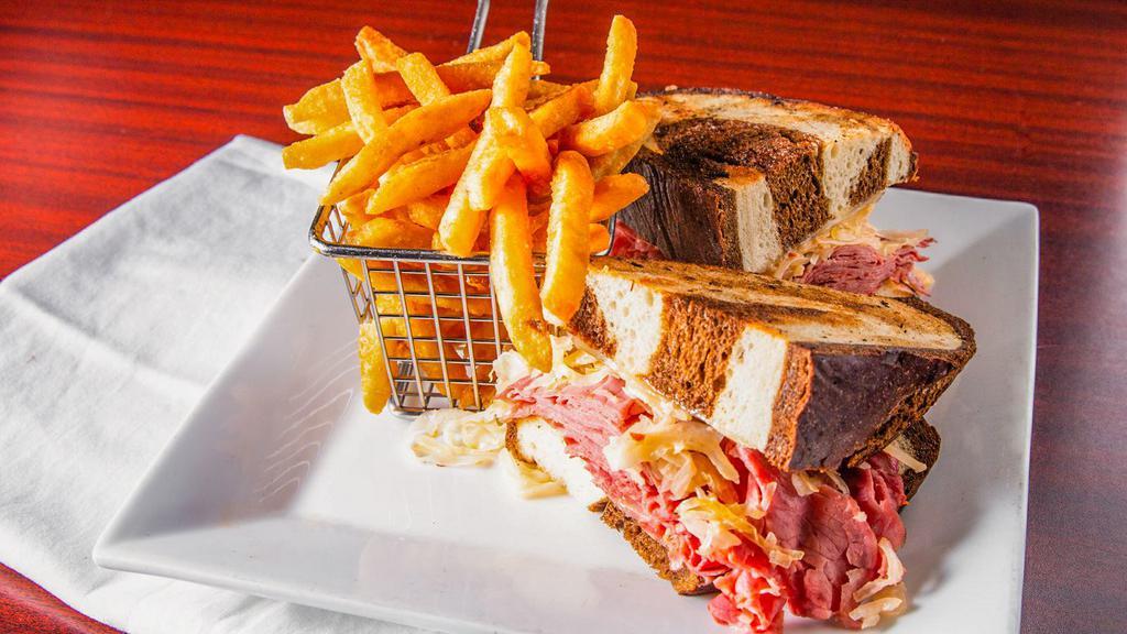 Deli Style Reuben · Hand-carved corned beef piled high on thick- cut marble rye, sauerkraut, Swiss cheese and Thousand Island dressing.