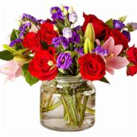 The Ftd® Truly Stunning™ Bouquet · Comprised of vivid red roses, purple double lisianthus, pink lilies and red spray roses with...