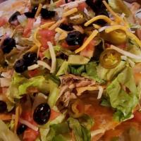 Nacho Grande · Tortilla chips smothered in melted cheese, beef, chicken, or pork, lettuce, tomatoes, black ...