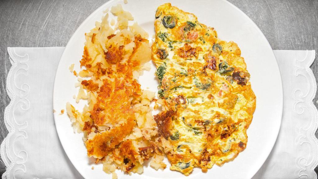 Corned Beef Hash Omelette · Omelettes are made with three eggs and served with fried potatoes.
